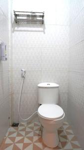 a bathroom with a toilet in a tiled room at Savira Golo Koe Labuan Bajo in Komodo Labuan Bajo Airport +40 photos