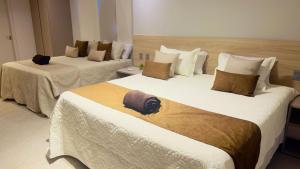 Ένα ή περισσότερα κρεβάτια σε δωμάτιο στο Mansão em Guarajuba – 7 Suítes a 50m da Praia!