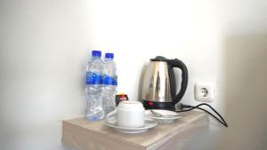 a shelf with two bottles of water and a coffee maker at Savira Golo Koe Labuan Bajo in Komodo Labuan Bajo Airport