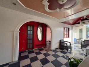 a red door in a room with a checkered floor at Apartamento Monterrey in Monterrey