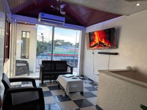 a living room with a tv and a fireplace at Apartamento Monterrey in Monterrey