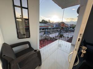 a balcony with a chair and a view of a city at Apartamento Monterrey in Monterrey