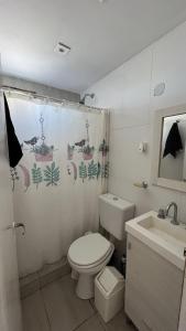 a bathroom with a toilet and a sink at La gracie in San Bernardo +21 photos