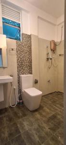a bathroom with a toilet and a sink at mountain retreat in Kandy