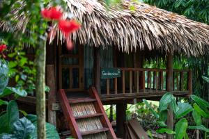 a small hut with a chair and a sign on it at Pù Luông Ecolodge in Pu Luong