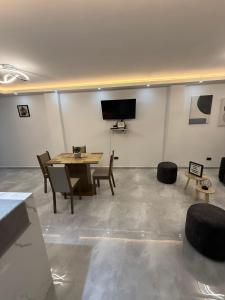 a room with a table and chairs and a flat screen tv at Apartamento Aluke in Cali +30 photos