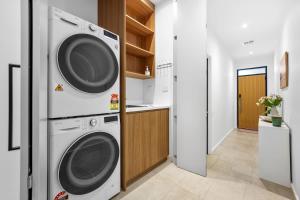 una lavanderia con lavatrice e asciugatrice di Stylish 2BR Home in Doncaster with parking a Doncaster