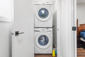 a washing machine and a washer in a room at Spacious Home • 3BR • Close to Whyte and Downtown in Edmonton