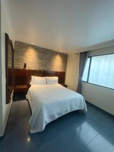 a bedroom with a large bed and a large window at Lavid Hotel Palacio Real in Bogotá +96 photos
