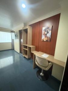 a office with a desk and a chair in a room at Lavid Hotel Palacio Real in Bogotá