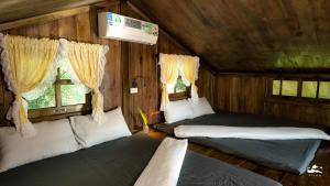 Postel nebo postele na pokoji v ubytování Xieng Retreat