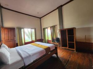 Ένα ή περισσότερα κρεβάτια σε δωμάτιο στο Istana Petani