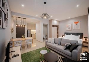 a living room with a couch and a living room and a kitchen at Iconic Regency Service Residences, managed by Iconic Hotel in Bayan Lepas