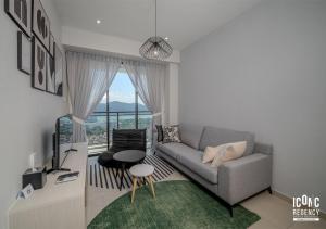 a living room with a couch and a table at Iconic Regency Service Residences, managed by Iconic Hotel in Bayan Lepas