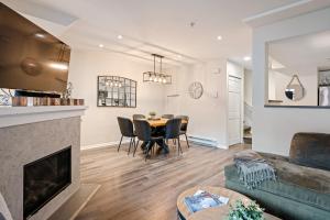 a living room with a fireplace and a table and chairs at Private Hot Tub | Pool | AC | Free Parking in Whistler