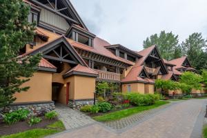 a large building with a pathway in front of it at Private Hot Tub | Pool | AC | Free Parking in Whistler