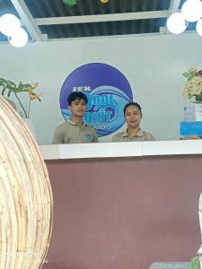 two men standing on a sign behind a counter at Jex Poolpoint Villa in El Nido +15 photos