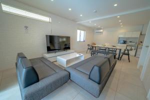 a living room with a couch and a tv at Grandioso Onna 7-D - Vacation STAY 17402v in Atsutabaru