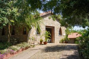 Casa Juliana vista al mar piscina y jacuzzi في Tubará: منزل حجري امامه ممر