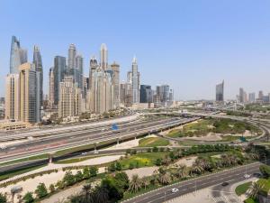 a highway in front of a large city with skyscrapers at Pullman Dubai Jumeirah Lakes Towers in Dubai