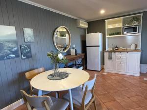 a kitchen and dining room with a table and a refrigerator at Windsor Retreat City Views - Garden Suite in Brisbane +16 photos