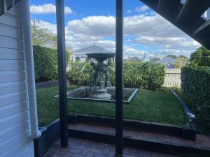 a view of a fountain in the yard of a house at Windsor Retreat City Views - Garden Suite in Brisbane