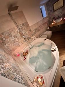 a bathroom with a bath tub with a tub at Il Borgo Guest House Subiaco in Subiaco