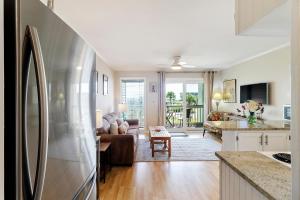a kitchen and living room with a refrigerator at SC206A: 206A Sea Cabin in Isle of Palms