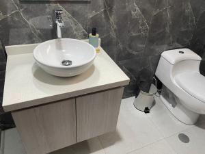 a bathroom with a sink and a toilet at Hotel Florez Boutique in Arequipa
