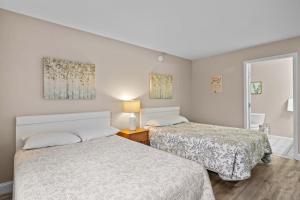 a bedroom with two beds and a window at Torch Lake Vista A Ga Ming Golf Retreat 741 Unit 9A in Creswell