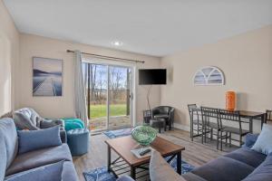 a living room with two couches and a table at Torch Lake Vista A Ga Ming Golf Retreat 741 Unit 9B in Creswell