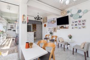 a restaurant with tables and chairs and a tv on the wall at Take a Rest Donmueang in Ban Don Muang