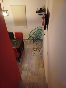 a hallway with two chairs and a table and a mirror at Altos Aparts cabañas in Estancia Vieja +50 photos