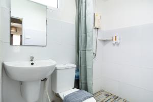 a bathroom with a sink and a toilet and a mirror at Take a Rest Donmueang in Ban Don Muang +34 photos