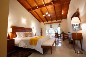 a bedroom with a large bed and a desk at Hotel & Spa Quinta Sauz in Tacámbaro de Codallos +49 photos