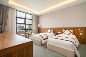 Ένα ή περισσότερα κρεβάτια σε δωμάτιο στο TAO DAN hotel