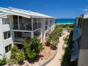 an aerial view of a building with the ocean in the background at Whalewatch Ocean Beach Resort in Point Lookout
