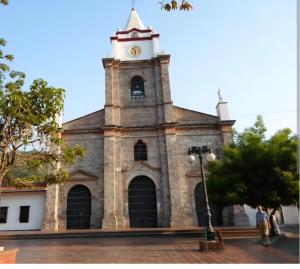 a church with a clock tower on top of it at Casa Hotel Vacacional Honda in Honda