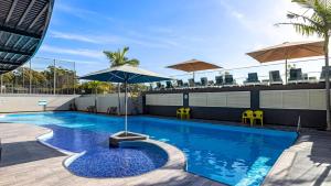 a swimming pool with an umbrella on top of a building at The Landmark- Top Level in Nelson Bay