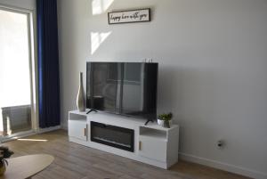 a flat screen tv sitting on a white entertainment center at BnB Vacation Home in Queen Creek