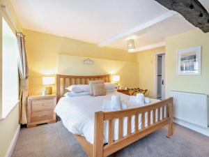 a bedroom with a large bed with a wooden frame at 3 Bed in Hawkshead Village LLH39 in Hawkshead