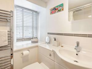 a white bathroom with a sink and a mirror at 3 Bed in Hawkshead Village LLH39 in Hawkshead +34 photos