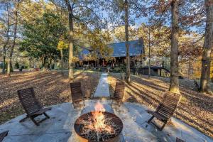 a fire pit in the middle of a patio with chairs at Secluded Lakeview Retreat 10 Mins to Leipers Fork in Kingfield