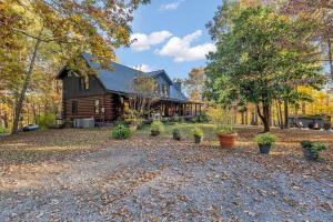 a barn with potted plants in front of it at Secluded Lakeview Retreat 10 Mins to Leipers Fork in Kingfield