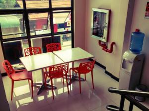a table and chairs in a room with a window at Cityinn Hotel in Zamboanga