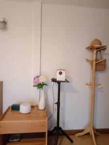 a room with a table and a shelf with a camera at Cozy Homey Doichang in Ban Muang Ngam