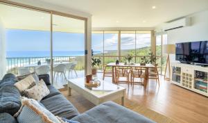 a living room with a couch and a table at Whalewatch Ocean Beach Resort in Point Lookout