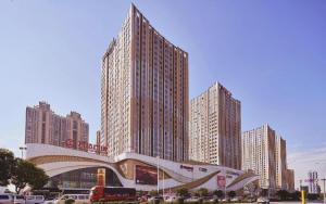 a large building in a city with tall buildings at Nanning Qian Xi International Hotel in Nanning