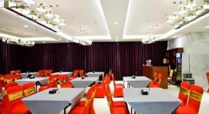 a dining room with white tables and orange chairs at Nanning Qian Xi International Hotel in Nanning +167 photos