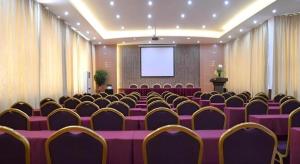 a conference room with purple tables and chairs and a screen at Nanning Hawks Holiday Hotel in Nanning